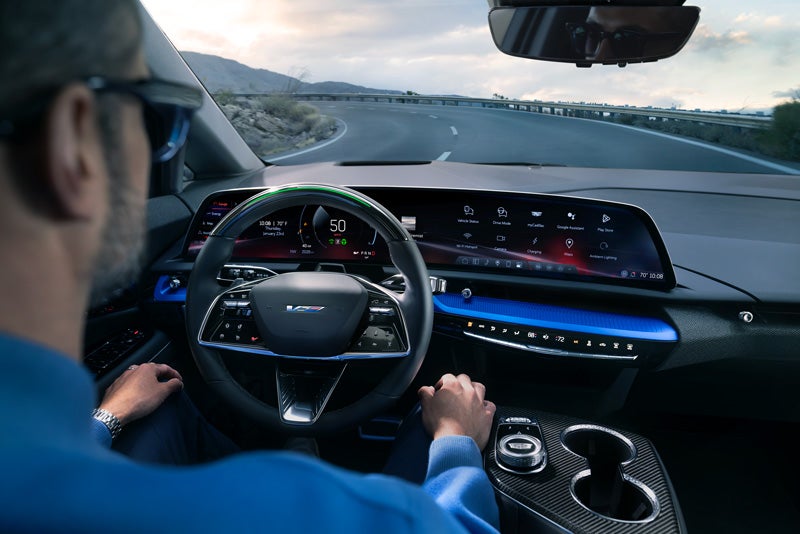Front View of the 2026 OPTIQ-V Driving Through the Dusk Utilizing its Headlights | Clay Cooley Cadillac in Mesquite TX